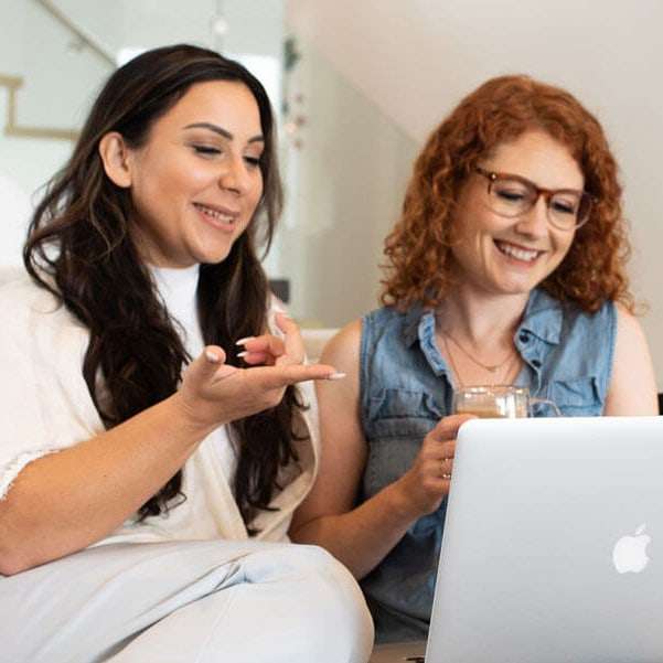 Mel and soph pointing at the computer